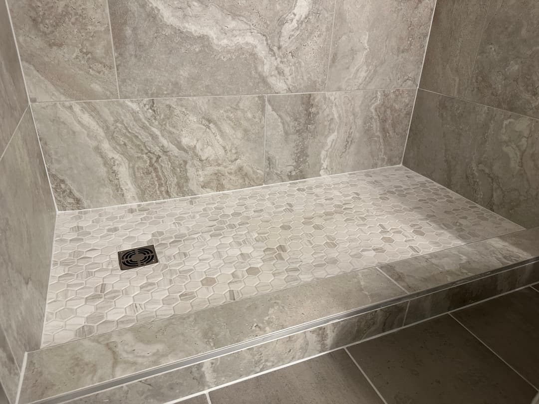 Remodeled luxury bathroom  tile shower with custom tile wall and  tile flooring